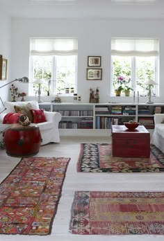 a living room filled with lots of furniture and rugs