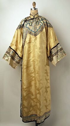 20th century Chinese Qipao // Medium: Light yellow silk, metal // Dimensions: Length: 59 1/2 in. (151.1 cm) // Credit Line: Gift of Mr. Alan L. Wolfe, 1961 // Accession Number: C.I.61.15.2 Chinese Robes, Yellow Silk, Traditional Clothes