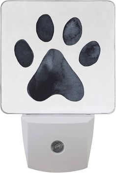 an animal paw print on a white night light with a black cat's paw