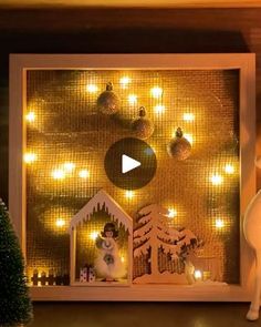 a white cat is standing in front of a christmas scene with lights and ornaments on the wall