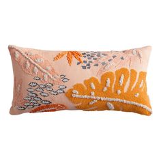 an orange and white decorative pillow on a white background