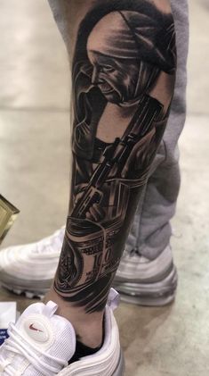 a person with a tattoo on their leg holding a coffee cup and money in his hand