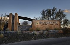 the entrance sign to fireside is shown in front of some bushes and trees with no leaves on them