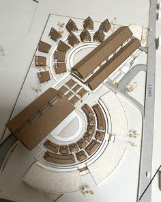 an aerial view of a building made out of cardboard and cut into smaller pieces with scissors