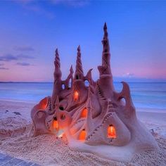 a sand castle made to look like it's been built on the beach at night