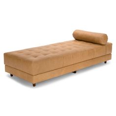 a tan couch with a rolled up pillow sitting on it's backrests