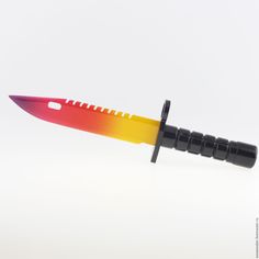 a knife that has been cut in half and is yellow, red, and orange