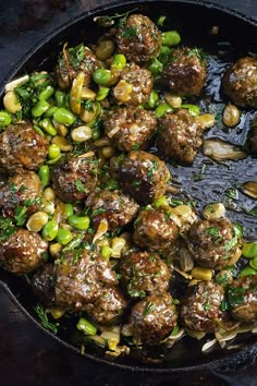 meatballs and vegetables cooking in a skillet