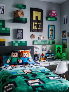 a bed room with a neatly made bed and minecraft decorations on the wall above it