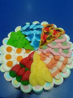 there are many different types of food on the plate together, including candy and cookies