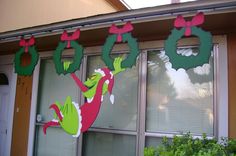 an image of a christmas decoration on the outside of a house that is decorated with green and red decorations