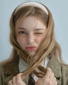 a woman with long hair wearing a tie