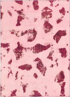 a pink rug with red spots on it