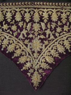 a purple and gold cloth with flowers on it