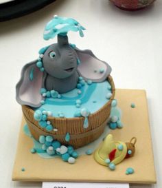 a cake with an elephant in the bathtub and a rubber duck