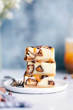 three pieces of cake sitting on top of a white plate next to a glass of orange juice