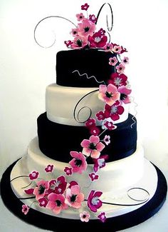 a three tiered wedding cake with white and blue flowers