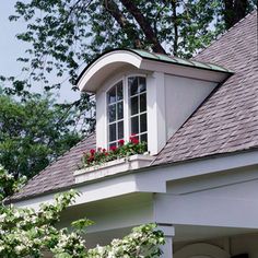 a white house with flowers in the window box