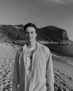 a man standing on top of a sandy beach