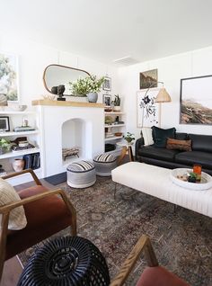 a living room filled with furniture and a fire place