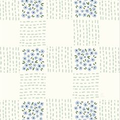 a white and blue flower pattern on a wallpaper background with green dots in the middle