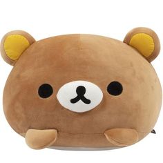 a brown teddy bear pillow with black eyes