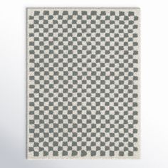 a gray and white checkered rug hanging on the wall