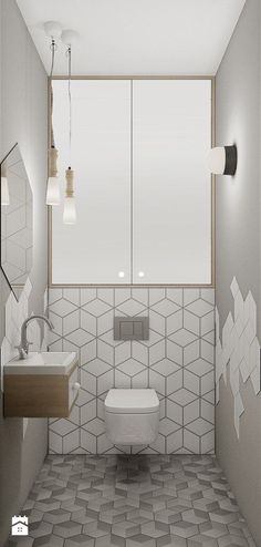 a white toilet sitting next to a bathroom sink under a window in a room with tiled walls