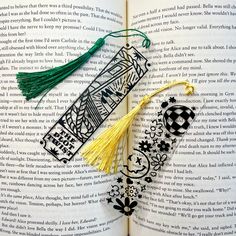 an open book with some tassels on it