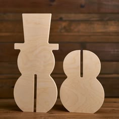 two wooden shapes sitting on top of a table