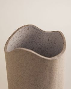 a gray vase sitting on top of a table