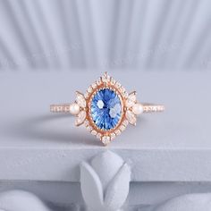 a ring with a blue stone surrounded by pearls