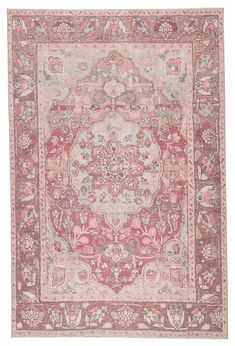 an antique rug with pink and grey colors