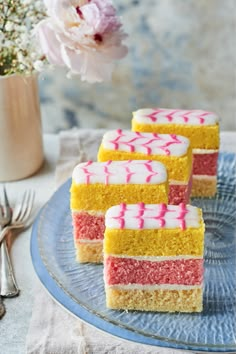 four pieces of cake sitting on top of a blue plate