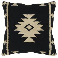 a black and white pillow with an arrow design on the front, sitting on a white background