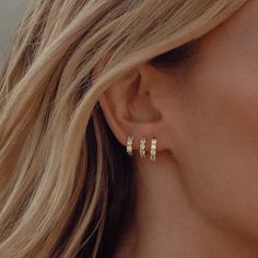 Meet the Skye Hoop in 14k Gold Vermeil, our most sparkling earring yet. Studded with White Cubic Zirconia, these hoops are designed to let as much light in as possible, making them truly sparkle from every angle. Available in three versatile sizes—8mm, 6.5mm, and 5.5mm—these hoops are perfect for lobe stacking or wearing in cartilage piercings, allowing you to create a personalised ear stack that shines. Whether worn solo or layered with other pieces, the Skye Hoop is destined to become your go-to earring for adding a touch of brilliance to any look. Sold as a single earring.Materials: 925 Sterling Silver With a 2.5 Micron Plating Of 14k GoldGems: 2.5mm White Cubic Zirconia Three Ear Piercings, Face Mask Brands, Mens Clothing Brands, Cartilage Piercings, Gift Wrap Tags, Ear Stack, Single Earring, New Classic, Silver Hoop Earrings