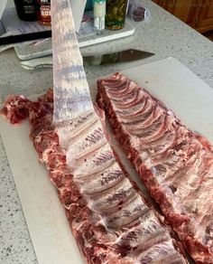 two pieces of raw meat on a cutting board