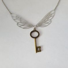 "This whimsical necklace features a pair of stainless steel wings with a little bronze key dangling underneath them.  The keys from the outer tip of one to the outer tip of the other is 4\" wide.  The key dangling from where the wings meet is a touch over 1 1/2\" long.  This necklace is available in many lengths and you can choose from 16 18 20 22 24 or 30\".  The chain is made of stainless steel and finished with a lobster claw style clasp. Thanks!" Whimsical Necklace, Skeleton Key Necklace, A Skeleton, Friend Necklaces, Skeleton Key, Key Necklace, The Keys, The Wings, Charm Necklaces