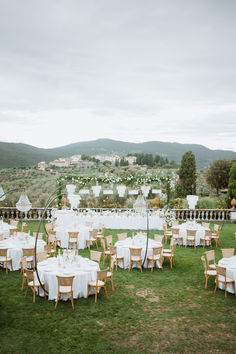 an outdoor wedding setup with tables and chairs