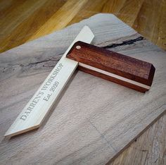 a personalized wooden knife on top of a piece of wood