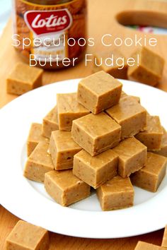 a white plate topped with pieces of cake next to a jar of peanut butter fudge