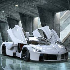 a white sports car with open doors in a parking garage