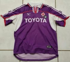 the jersey worn by toyota is on display in a room with tile flooring and white tiles