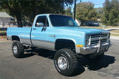 a blue pick up truck parked in a parking lot