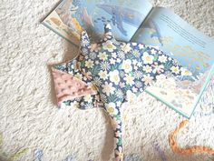 an origami star is laying on the floor next to two children's books