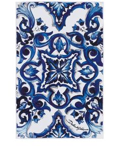 a blue and white tile with an intricate design