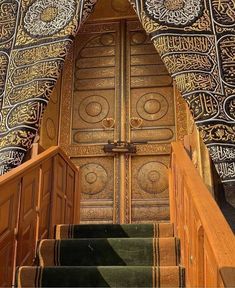 stairs leading up to an intricately decorated door