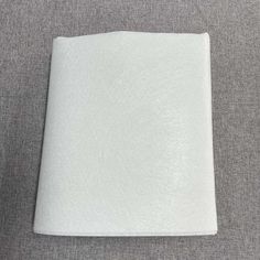 a white sheet of paper sitting on top of a gray surface