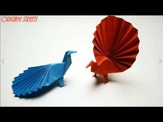 two origami birds sitting next to each other