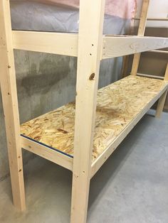 the bunk bed is made out of plywood and has no mattresses on it